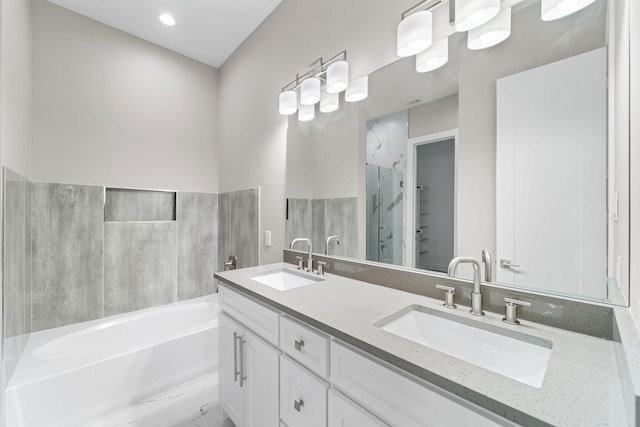 bathroom with vanity and independent shower and bath