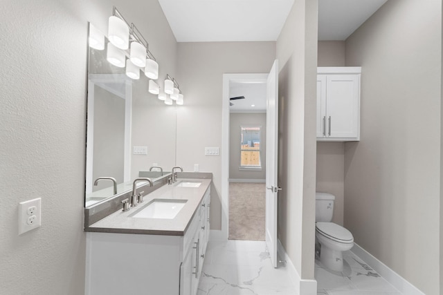 bathroom featuring crown molding, vanity, and toilet