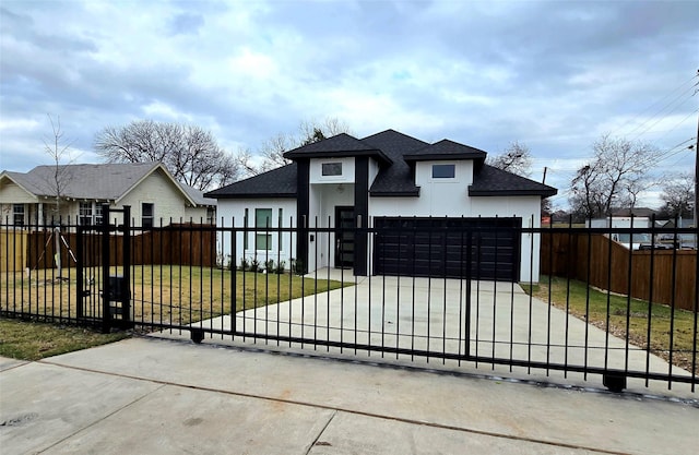 view of front of home with a garage and a front lawn