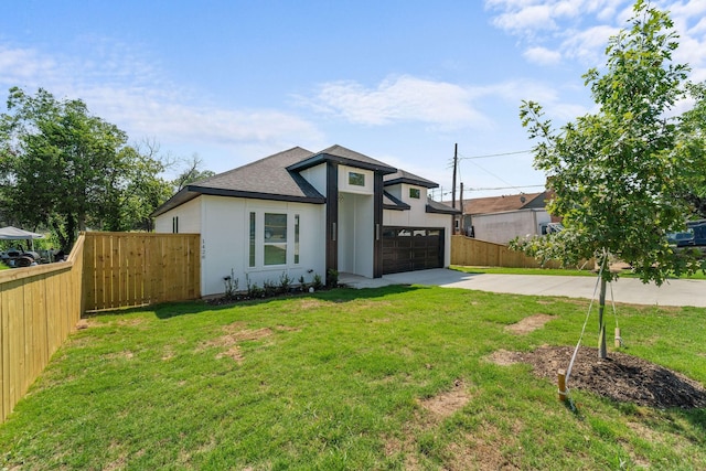 view of front of property with a garage and a front lawn