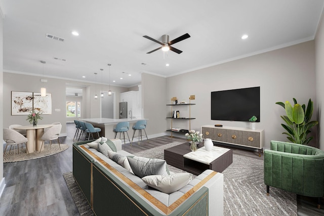 living room featuring crown molding, ceiling fan, and dark hardwood / wood-style floors