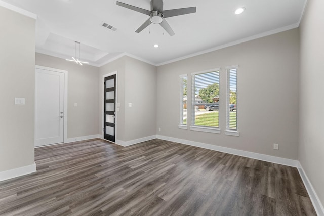 spare room with ceiling fan, dark hardwood / wood-style floors, and ornamental molding