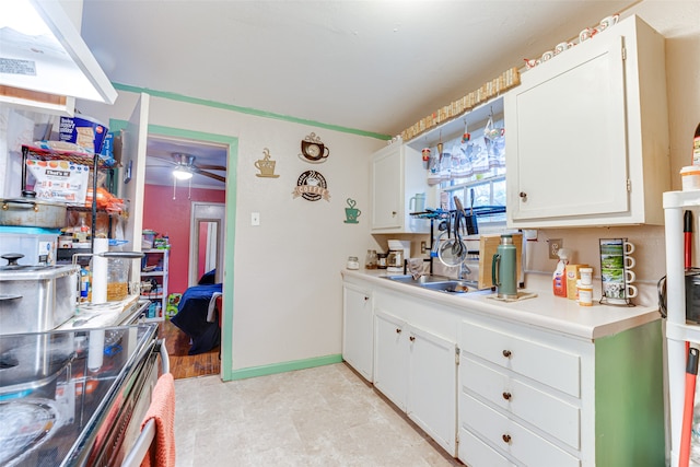 kitchen with light hardwood / wood-style flooring, sink, white cabinetry, stainless steel electric range oven, and ceiling fan