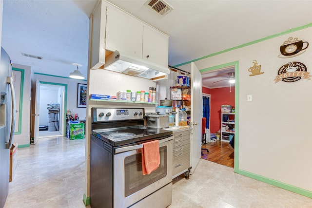 kitchen with appliances with stainless steel finishes, light hardwood / wood-style flooring, white cabinets, and ceiling fan