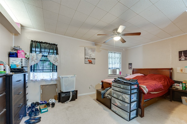 bedroom with ornamental molding, light colored carpet, and ceiling fan