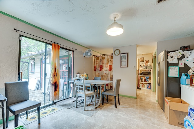 dining room featuring a textured ceiling