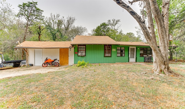 single story home featuring a carport, a front yard, and cooling unit