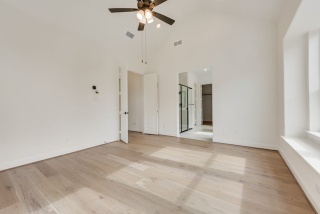 unfurnished room with light wood finished floors, visible vents, and a ceiling fan