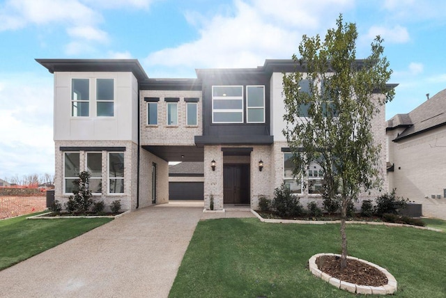 view of front facade featuring central AC, driveway, brick siding, and a front lawn