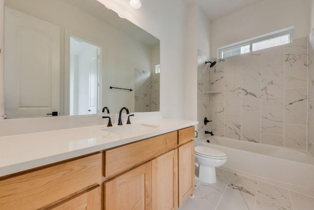 full bath featuring marble finish floor, shower / bath combination, vanity, and toilet