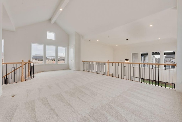 carpeted spare room featuring high vaulted ceiling, beamed ceiling, and recessed lighting