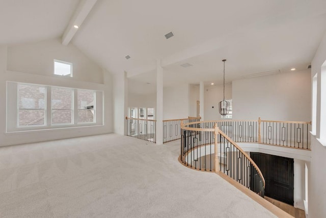 interior space featuring high vaulted ceiling, a notable chandelier, carpet flooring, visible vents, and beam ceiling