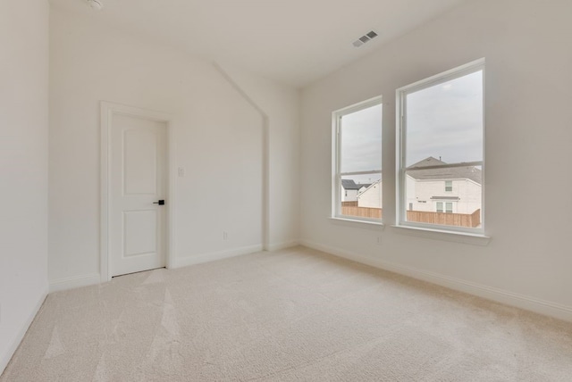 unfurnished room featuring carpet floors, visible vents, and baseboards