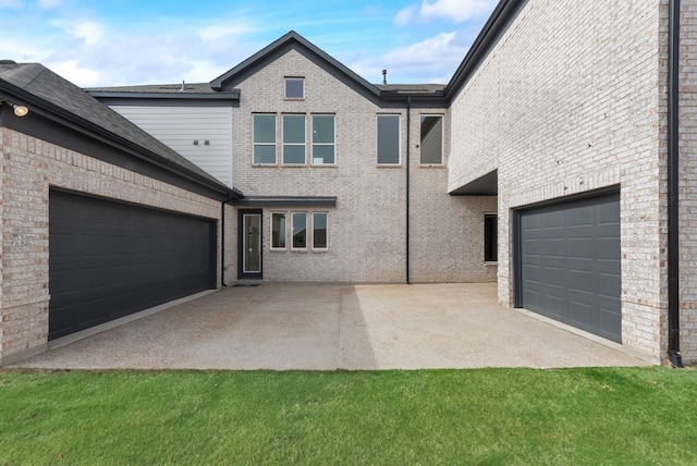 view of front of property featuring a garage and brick siding