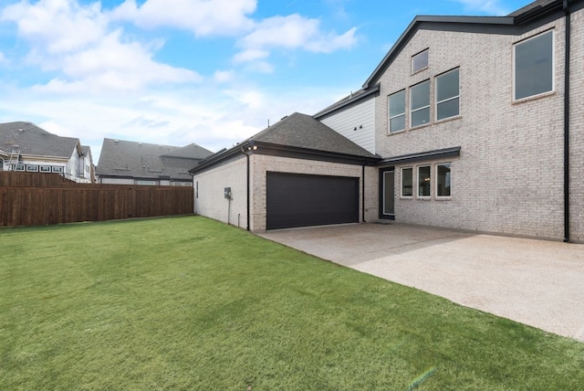 exterior space with a garage, driveway, and fence