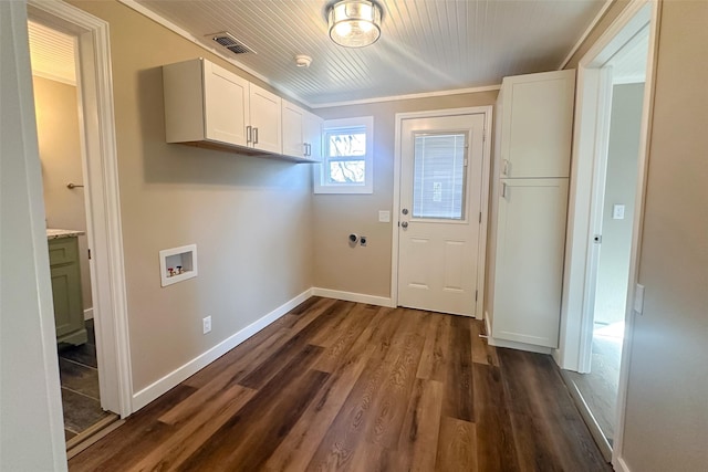 clothes washing area with cabinets, electric dryer hookup, dark hardwood / wood-style flooring, crown molding, and hookup for a washing machine