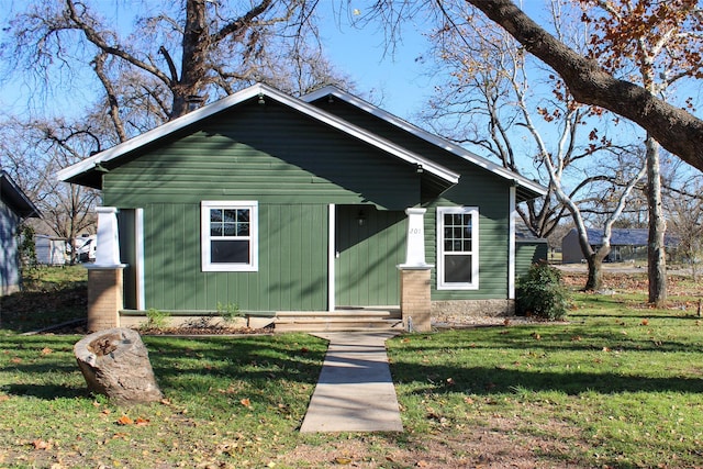 bungalow-style home with a front lawn