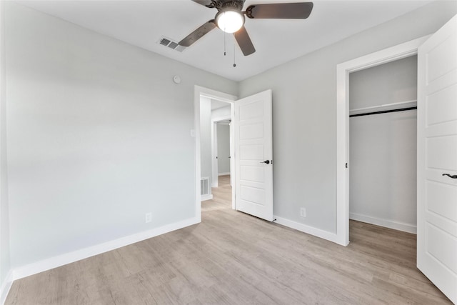 unfurnished bedroom featuring a closet, visible vents, light wood-style flooring, and baseboards