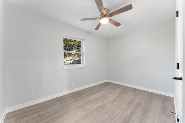 empty room featuring a ceiling fan, light wood-style floors, and baseboards