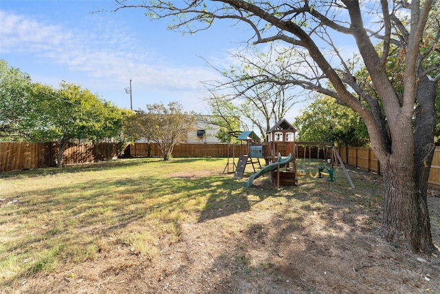 view of yard with a fenced backyard and a playground