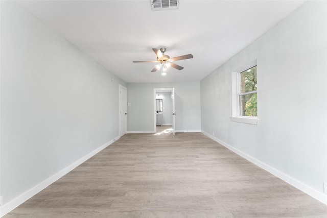 empty room with visible vents, baseboards, ceiling fan, and light wood finished floors