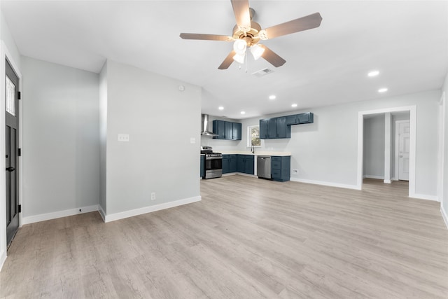 unfurnished living room with light wood-style floors, visible vents, and baseboards