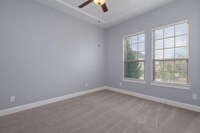 empty room featuring ceiling fan, a healthy amount of sunlight, and carpet floors