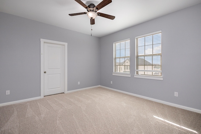 spare room with carpet and ceiling fan