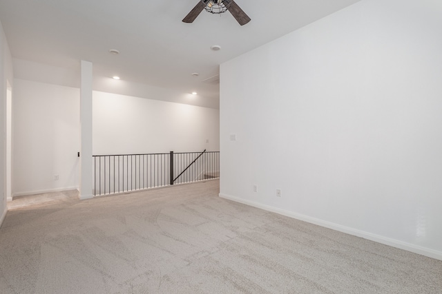 carpeted empty room featuring ceiling fan