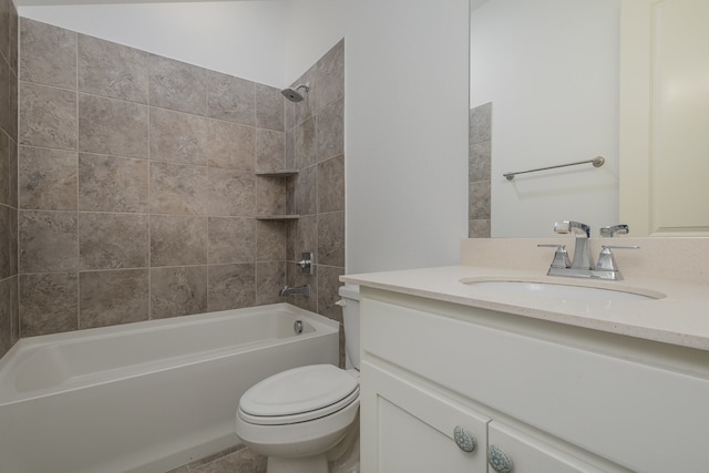 full bathroom with toilet, vanity, and tiled shower / bath