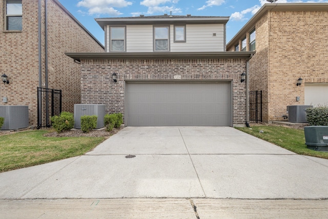 view of property with central AC unit and a garage