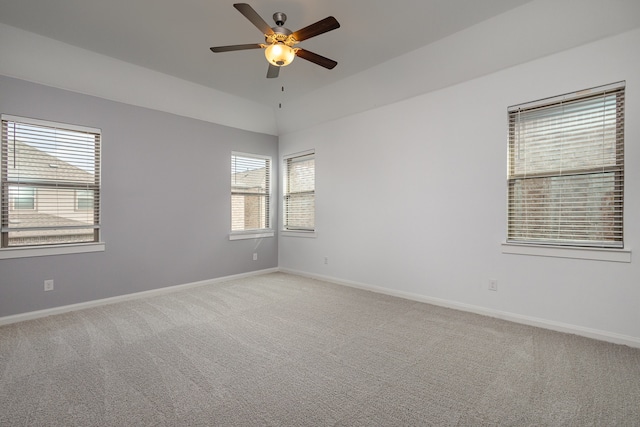 carpeted spare room with ceiling fan