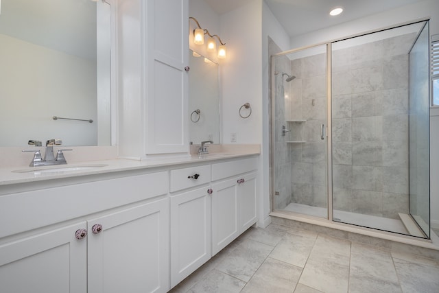 bathroom with an enclosed shower and vanity