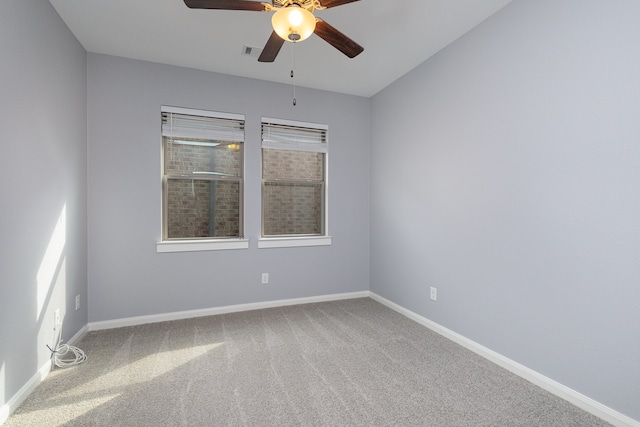 carpeted spare room featuring ceiling fan