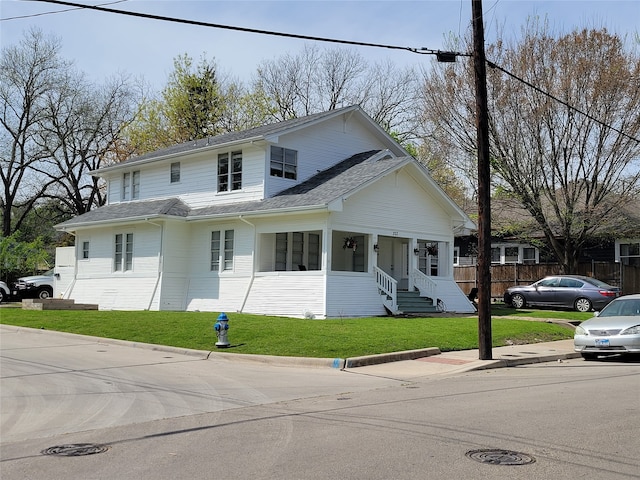 view of front property with covered porch and a front yard