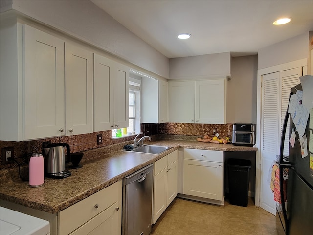 kitchen featuring decorative backsplash, dishwasher, sink, refrigerator, and white cabinets