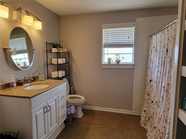 bathroom with vanity, a shower with curtain, toilet, and tile patterned floors