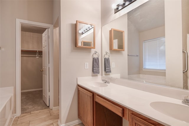 bathroom featuring vanity and a bath