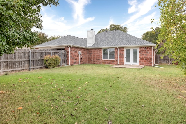 rear view of property with a patio area and a yard