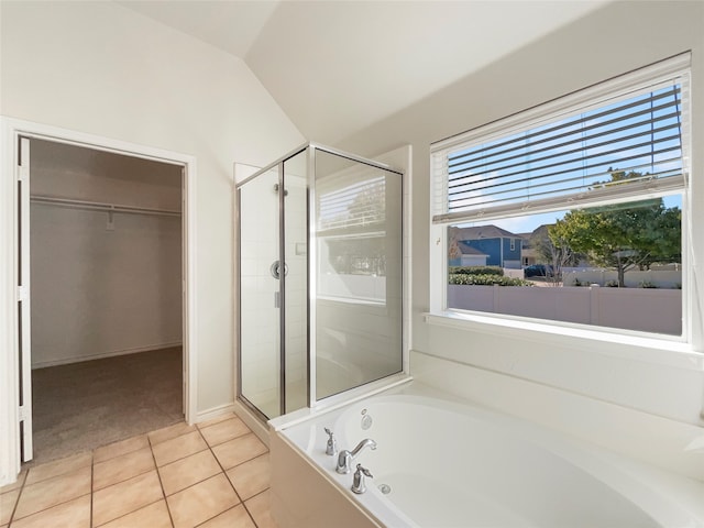 bathroom featuring tile patterned flooring, lofted ceiling, and separate shower and tub