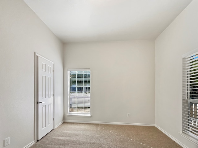 unfurnished room with light carpet