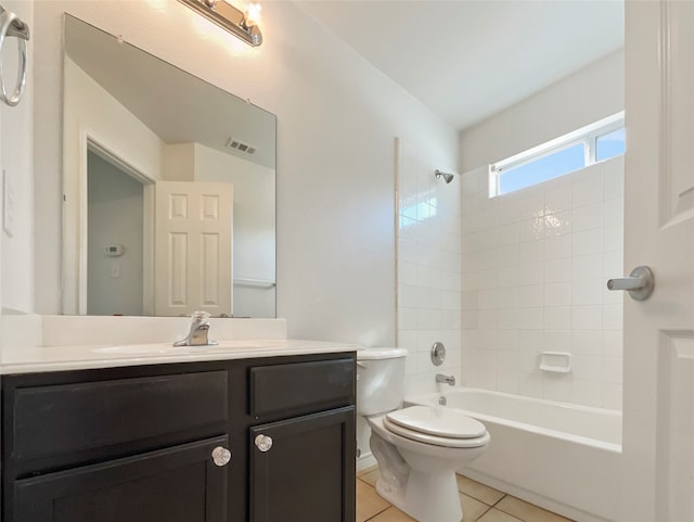 full bathroom featuring tile patterned flooring, vanity, toilet, and tiled shower / bath combo