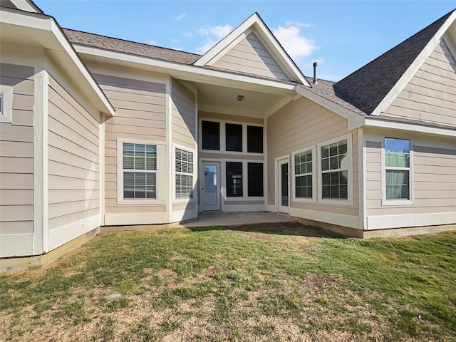 back of house featuring a yard and a patio area