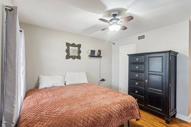 bedroom with hardwood / wood-style floors and ceiling fan