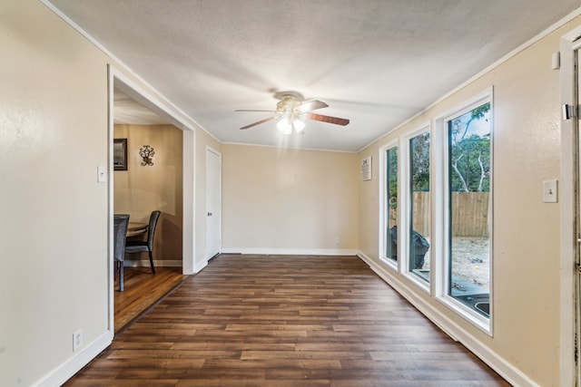 spare room with crown molding, a textured ceiling, ceiling fan, and dark hardwood / wood-style flooring