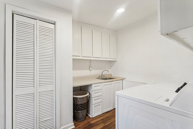 laundry area with cabinets, sink, washing machine and clothes dryer, and dark hardwood / wood-style flooring