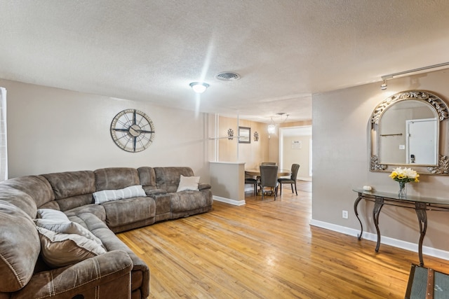 living room with hardwood / wood-style floors and a textured ceiling