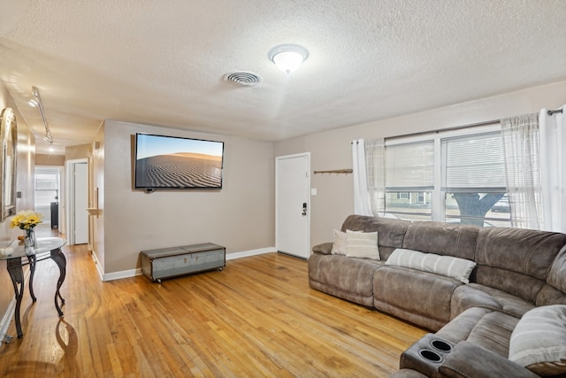 living room featuring hardwood / wood-style floors and a textured ceiling