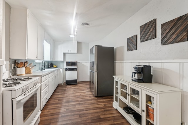 kitchen featuring sink, white cabinetry, stainless steel appliances, and dark hardwood / wood-style flooring