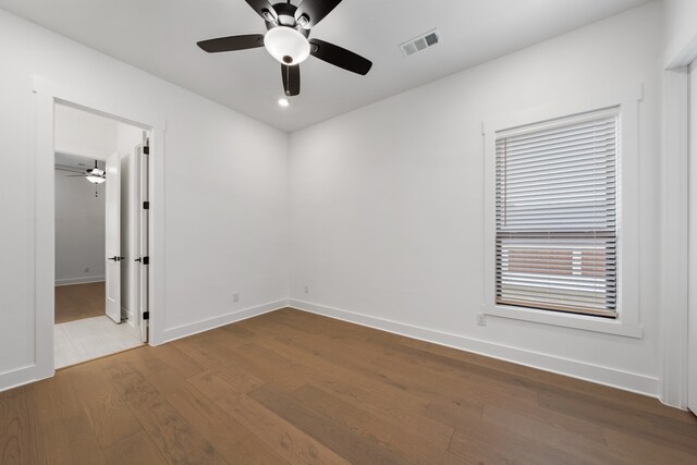 spare room featuring ceiling fan and hardwood / wood-style flooring